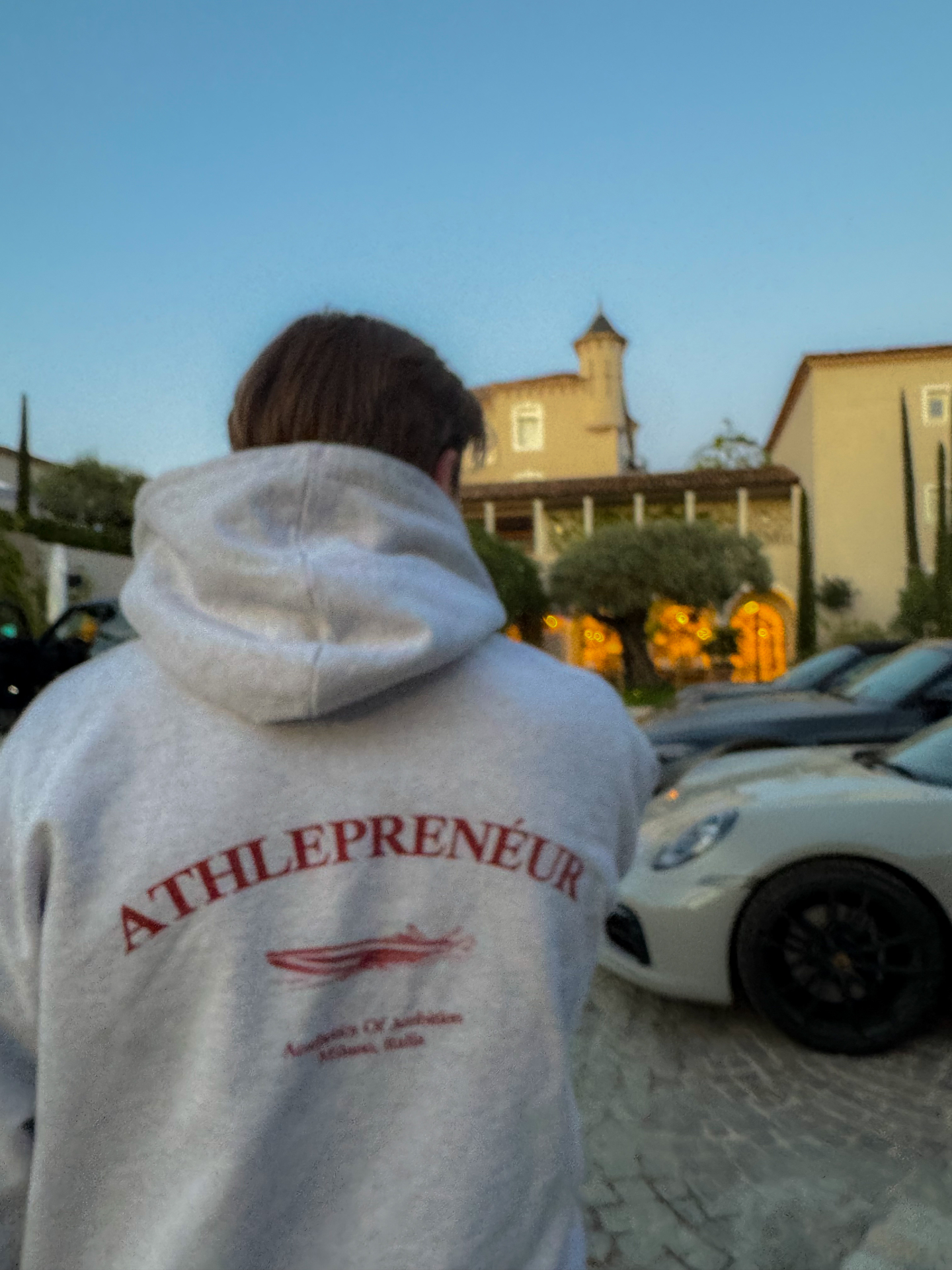 Athlepreneur hoodie moment outside a villa