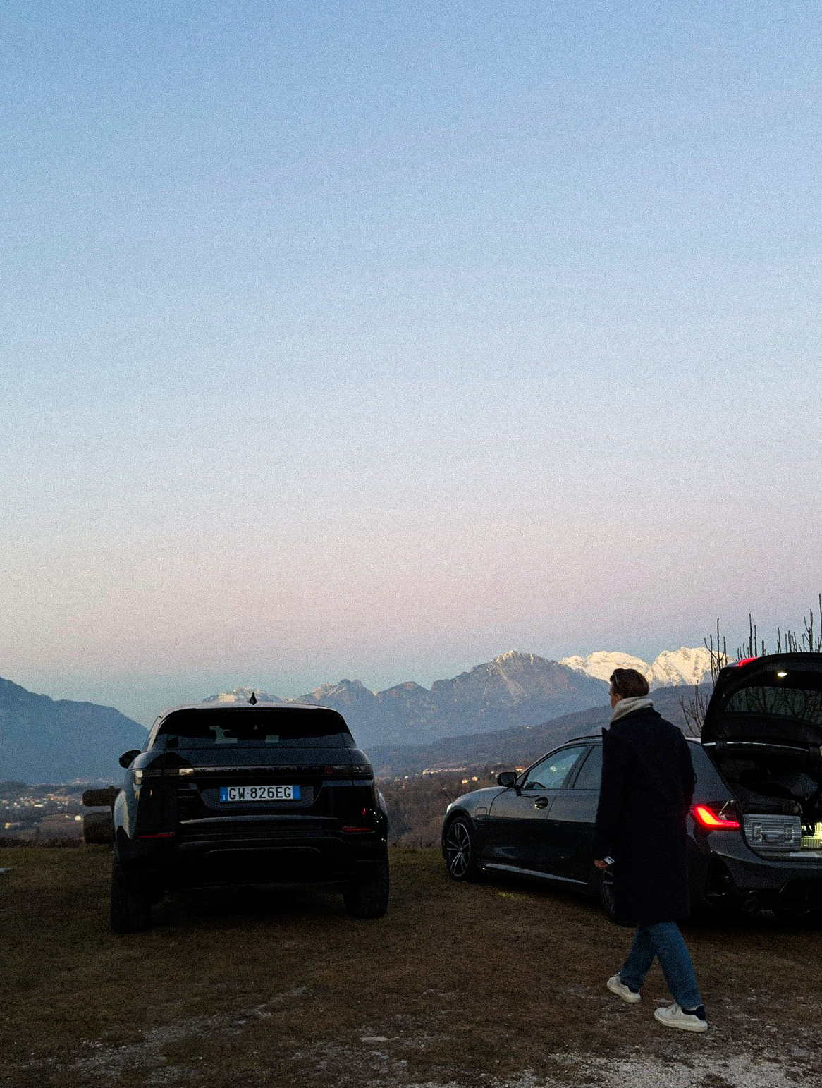 Mountain roadside stop with cars during sunset